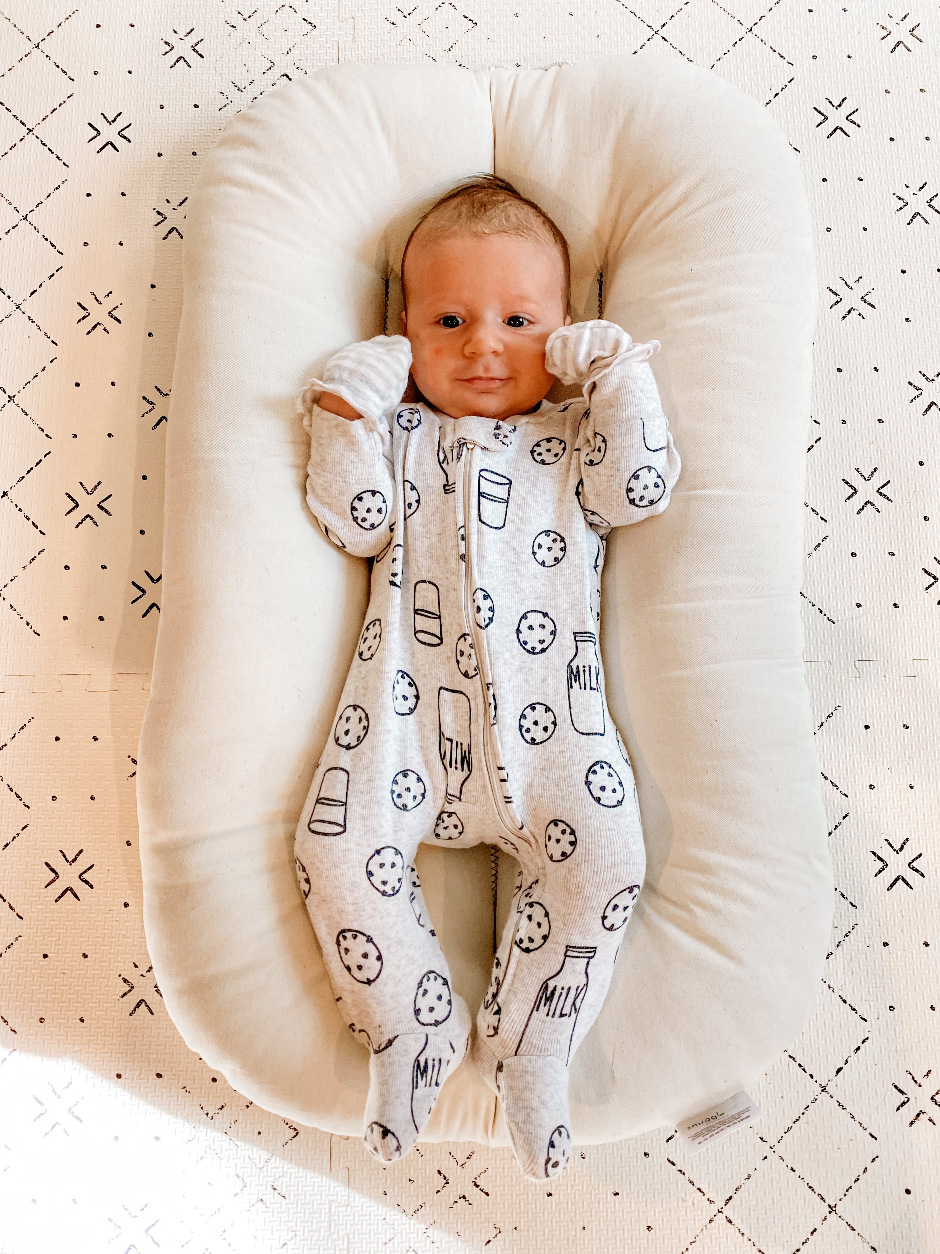 baby wearing footed pajamas from carter's (milk & cookies print)