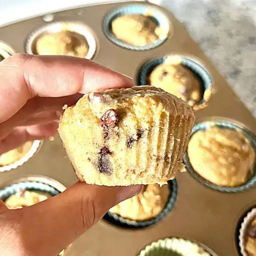 Healthy Peanut Butter Banana Muffins (pan in background, hand holding single muffin)