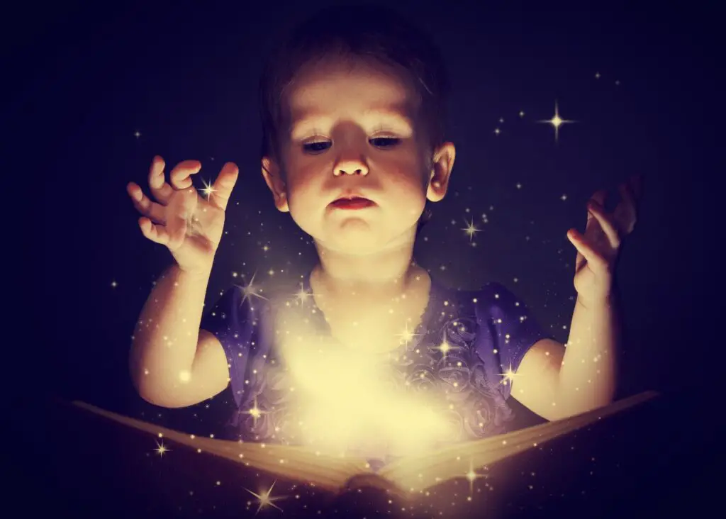 mystical girl names:
toddler girl with light sparkles coming out of a book with dark black background